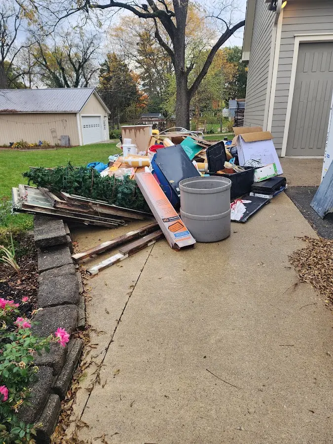 Dumpster being loaded with debris for 30 Yard Dumpster Rental in Bedford